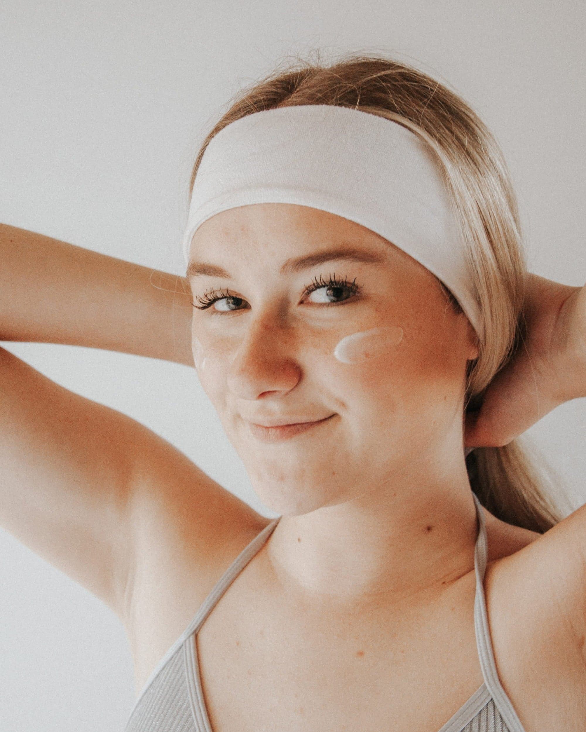 Woman stretching in a Pilates studio, mid-practice